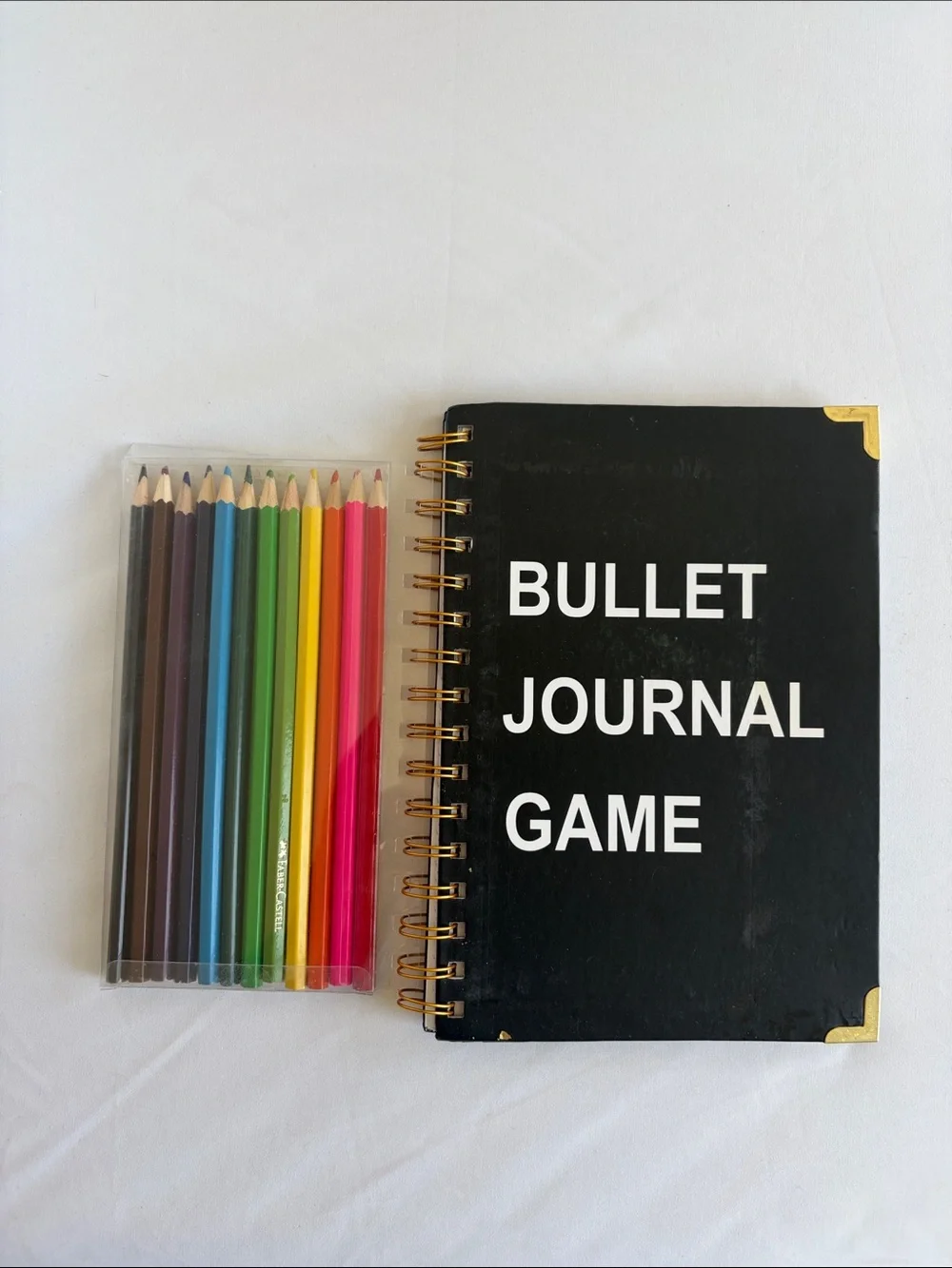 Bullet Journal Game Spiral Notebook in Black with Colored Pencils